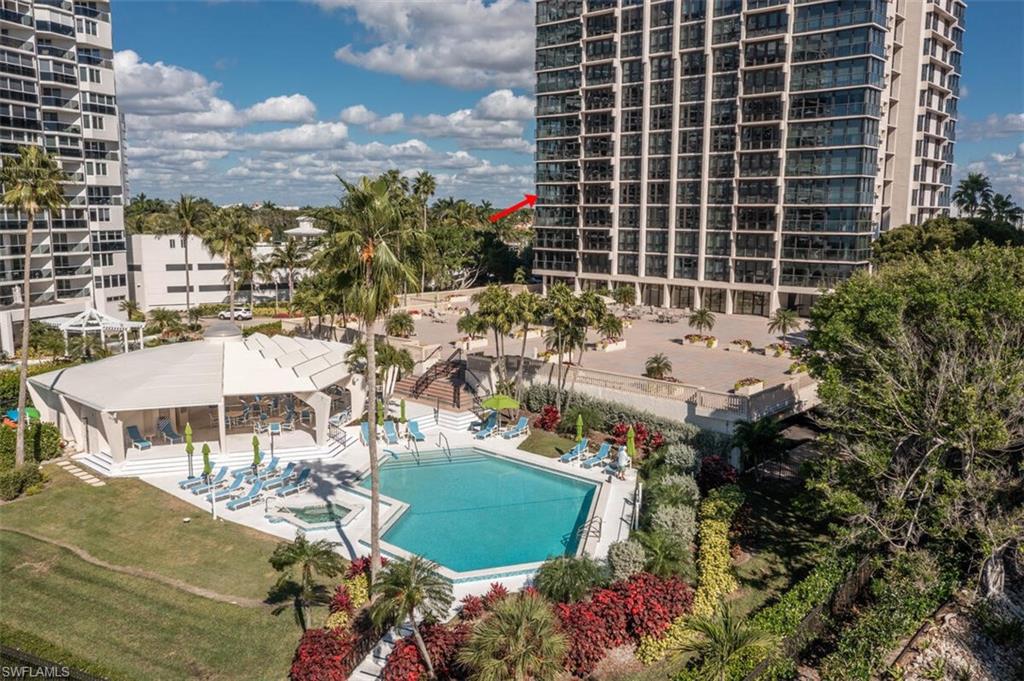 Community pool with a patio area, a lawn, and a jacuzzi