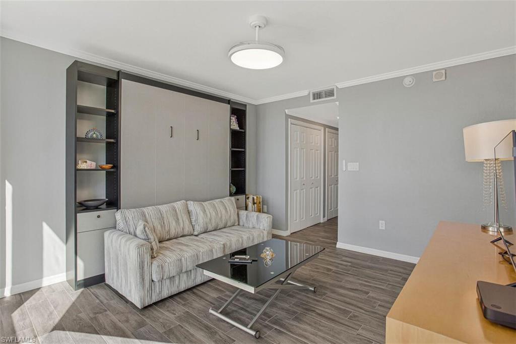 Living room with wood finish floors and crown molding