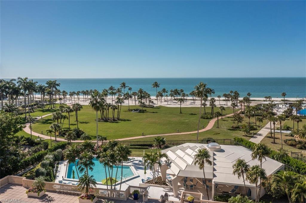 Aerial view of a pool area and a large body of water