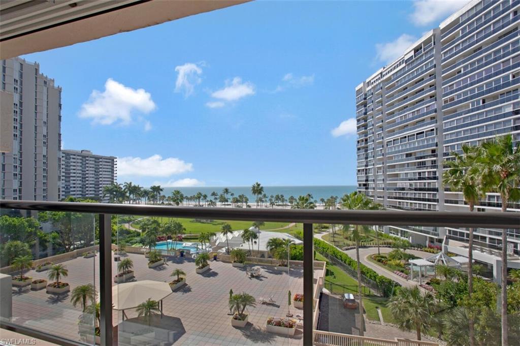 Balcony featuring a water view and a city view