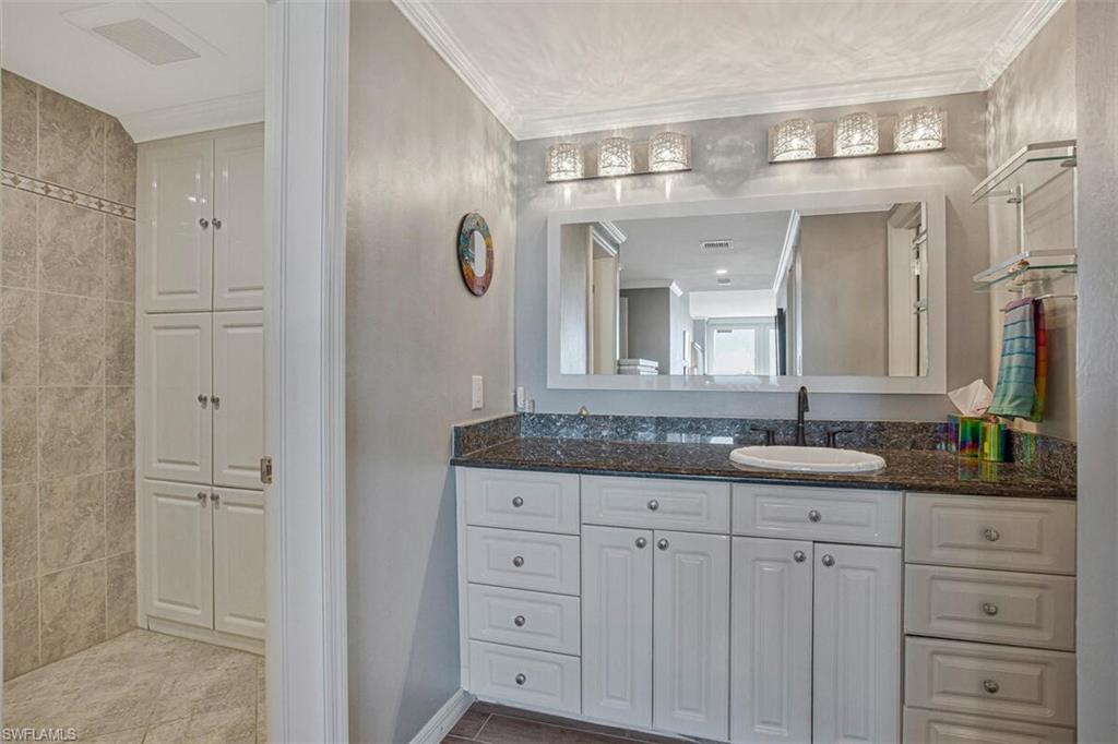 Bathroom featuring vanity and crown molding