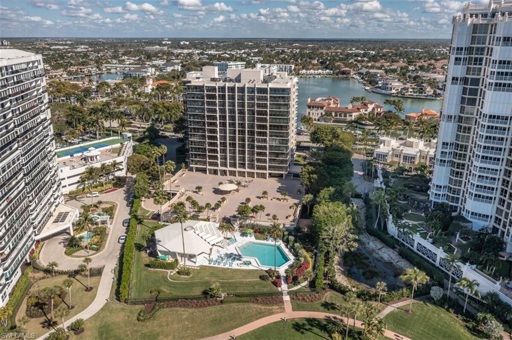View of urban area with a pool area and a large body of water