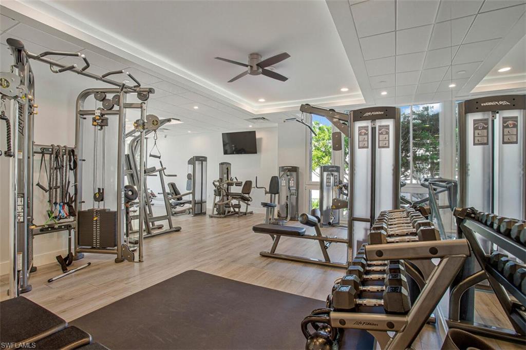 Gym with recessed lighting, ceiling fan, and expansive windows