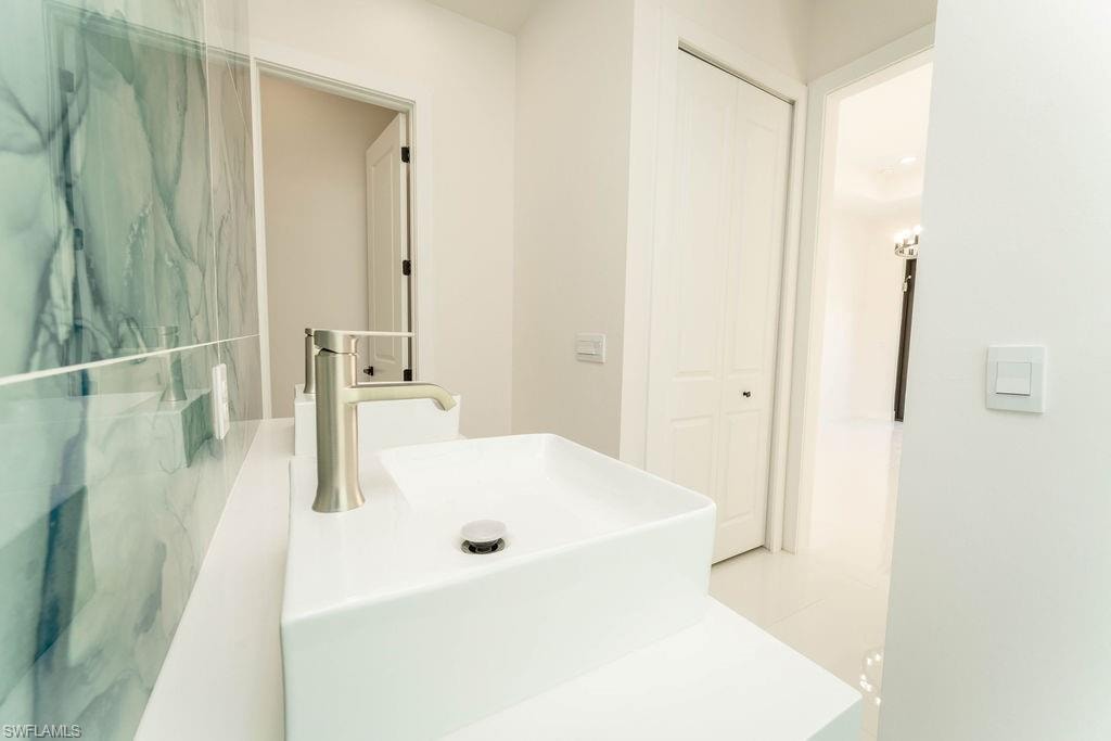 Bathroom with vanity and a closet