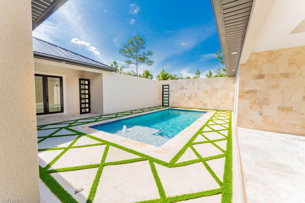 View of pool featuring a patio area and french doors