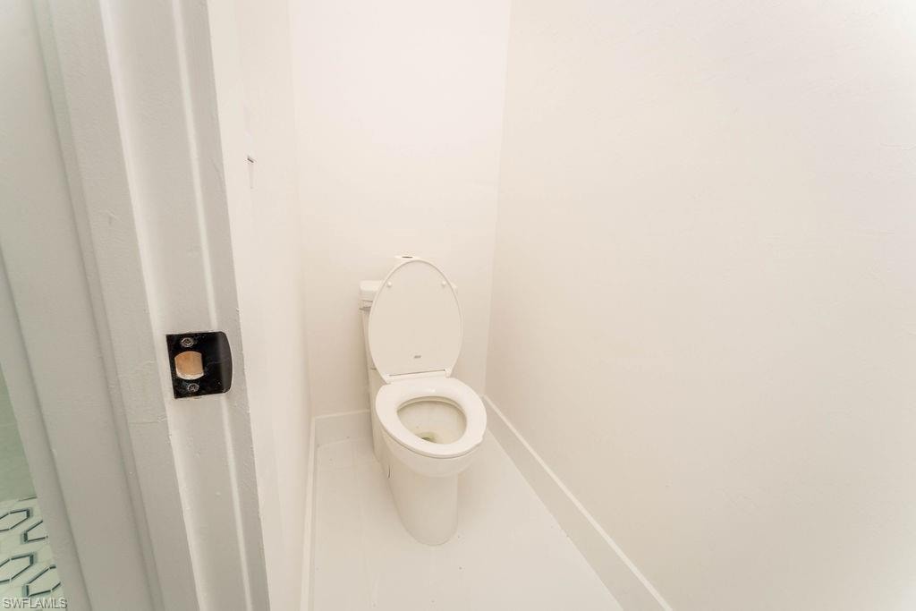 Bathroom featuring toilet and tile patterned flooring