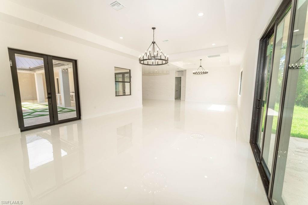 Unfurnished room with a chandelier and recessed lighting