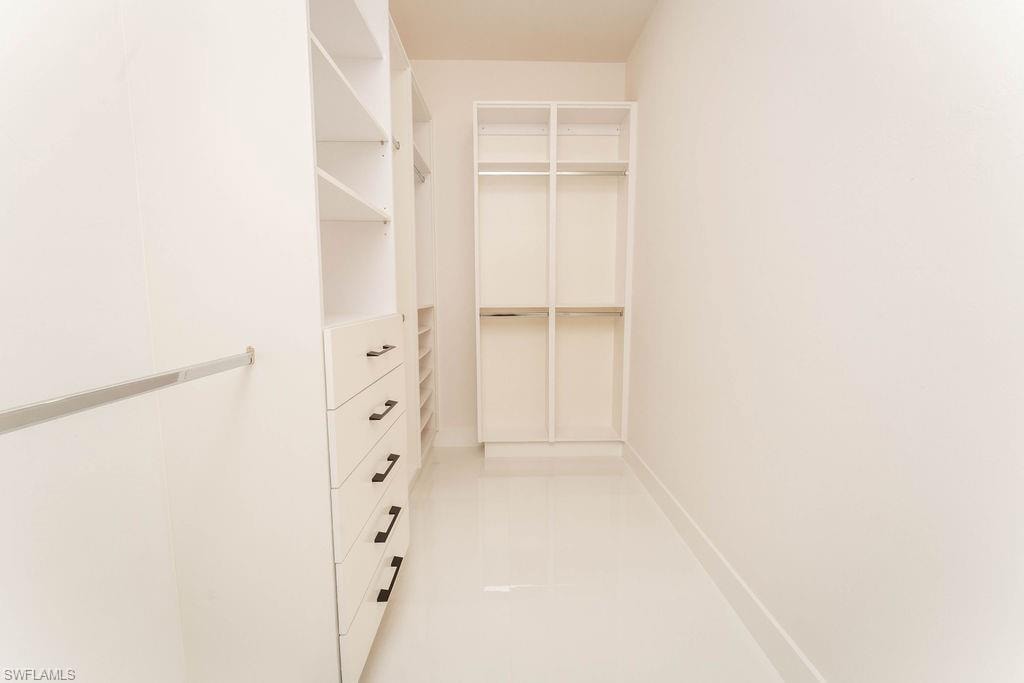 Spacious closet featuring light tile patterned flooring
