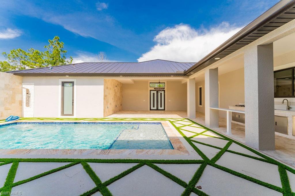 Swimming pool with a patio area and a sink