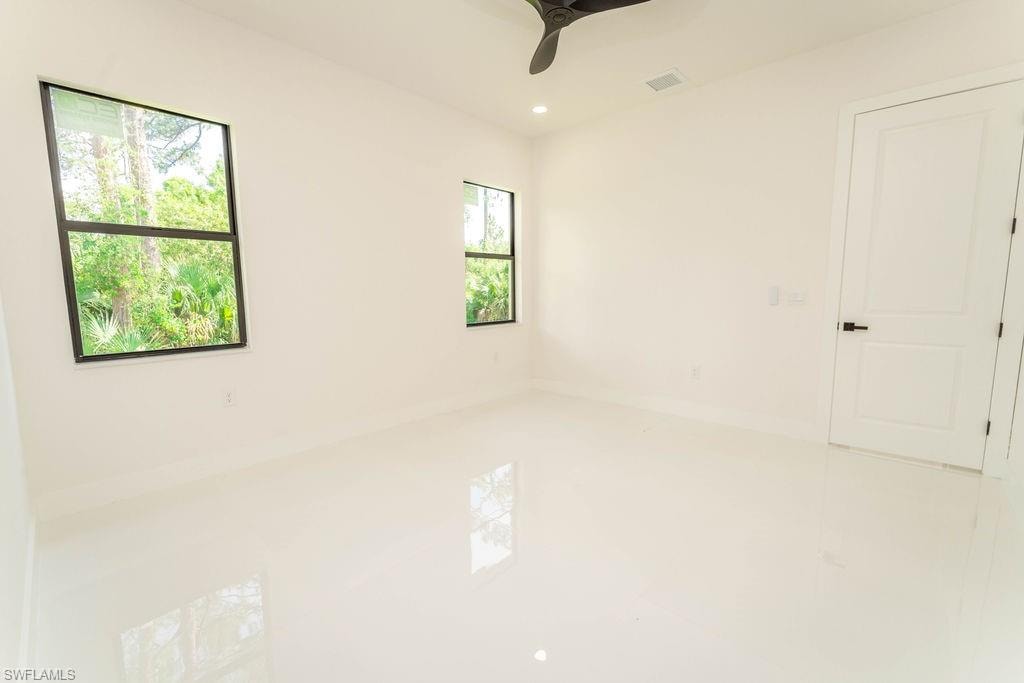 Tiled spare room with recessed lighting and a ceiling fan