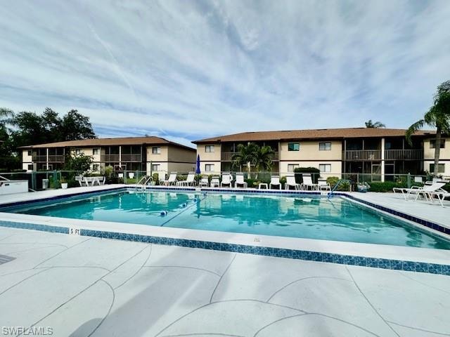 Community pool featuring a patio