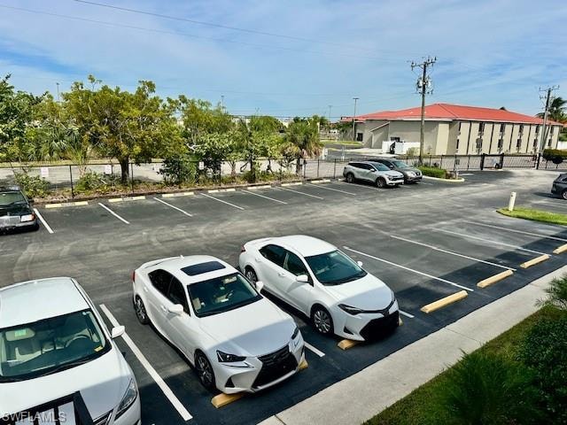 View of uncovered parking lot-1 assigned spot with plenty of guest parking