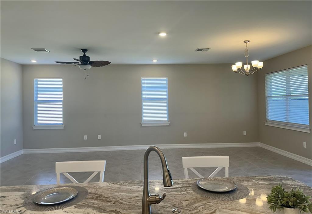 Kitchen featuring decorative light fixtures, a chandelier, ceiling fan, and recessed lighting