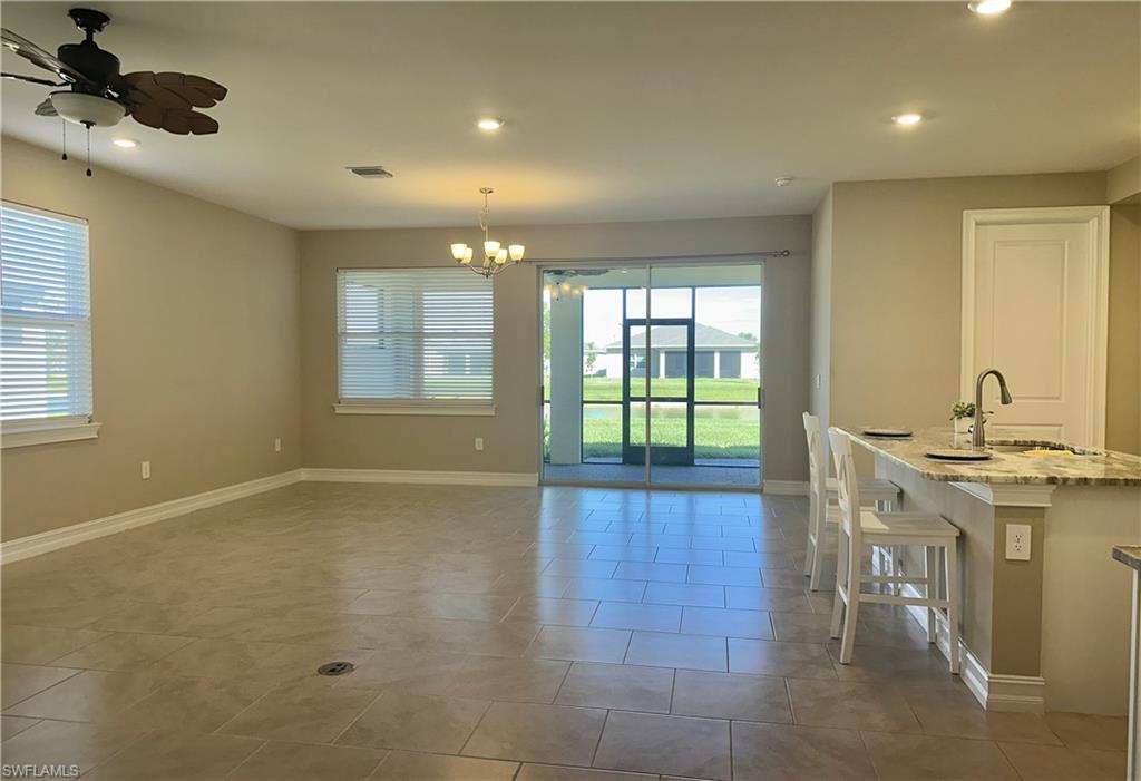 Dining area with recessed lighting, ceiling fan, a chandelier, and light tile patterned floors