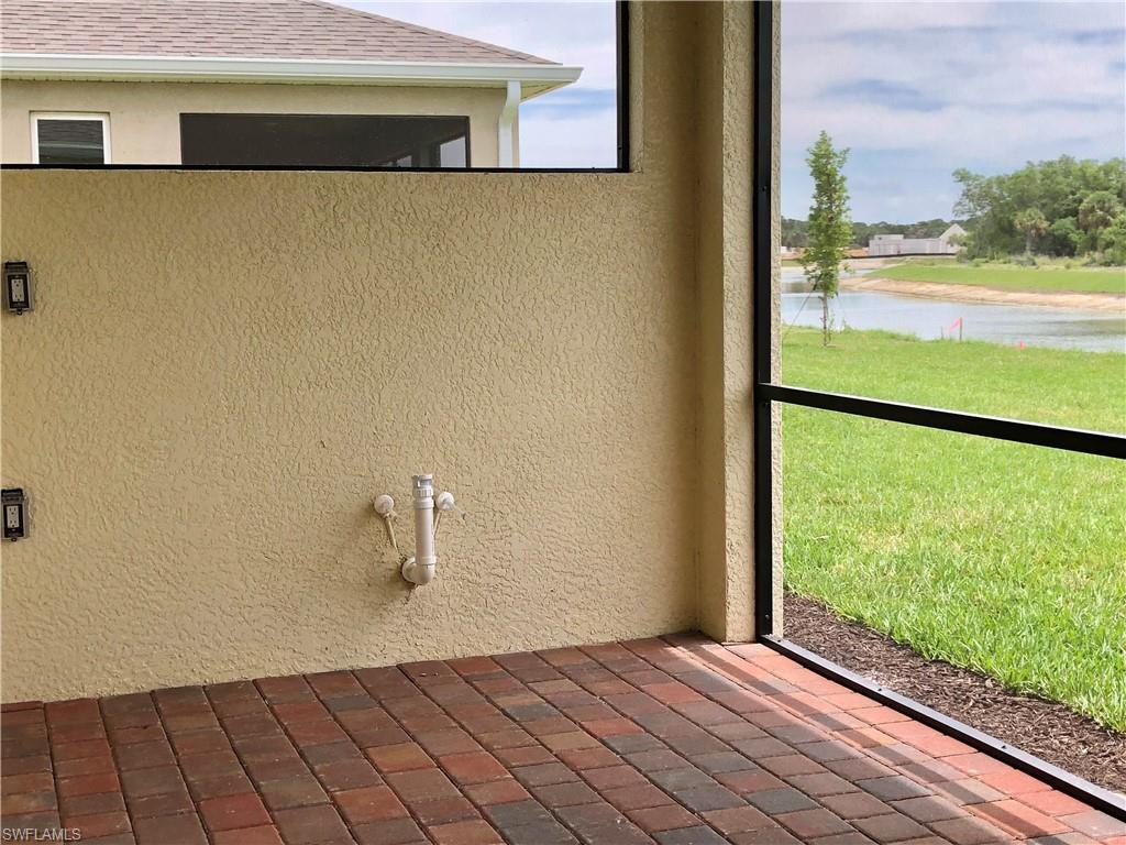 Exterior view of stucco siding, nearby water, and a downspout