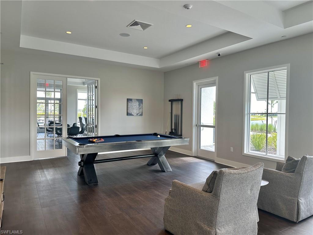 Recreation room with billiards table and recessed lighting