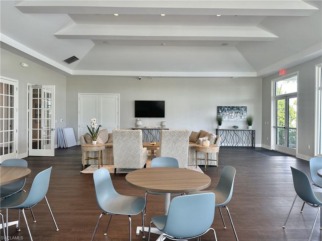 Dining area with french doors, dark wood-style flooring, vaulted ceiling, and recessed lighting