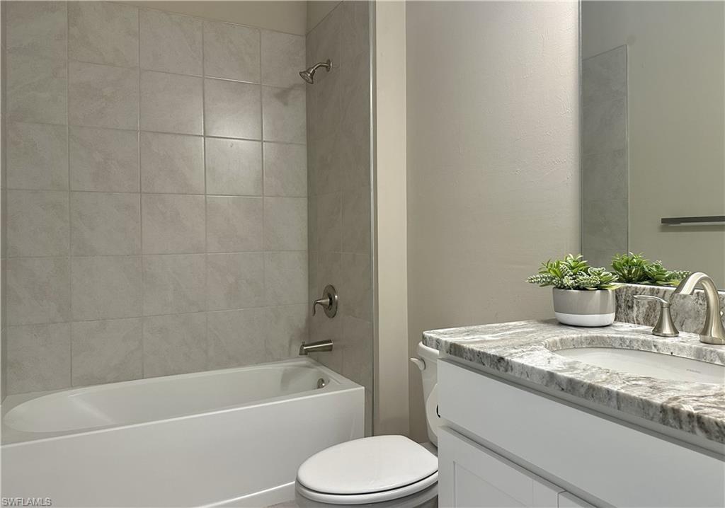 Bathroom featuring vanity and tub / shower combination