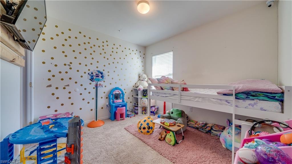 Bedroom featuring carpet flooring and wallpapered walls