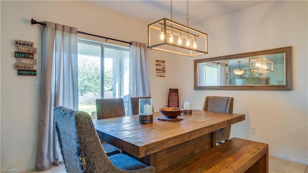Dining room featuring baseboards and light tile patterned floors