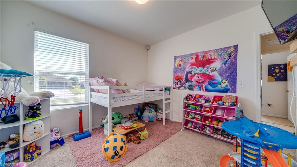 Bedroom with light carpet and baseboards
