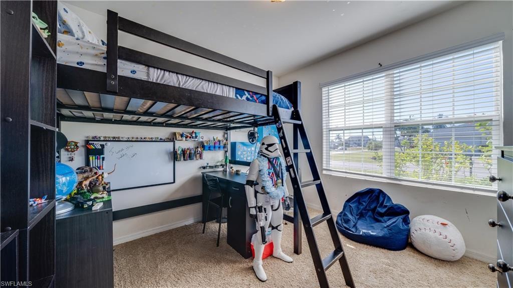 Bedroom with light carpet and baseboards