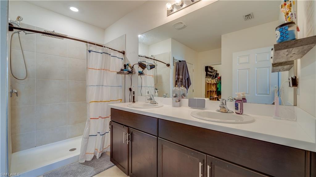 Bathroom with double vanity and a stall shower