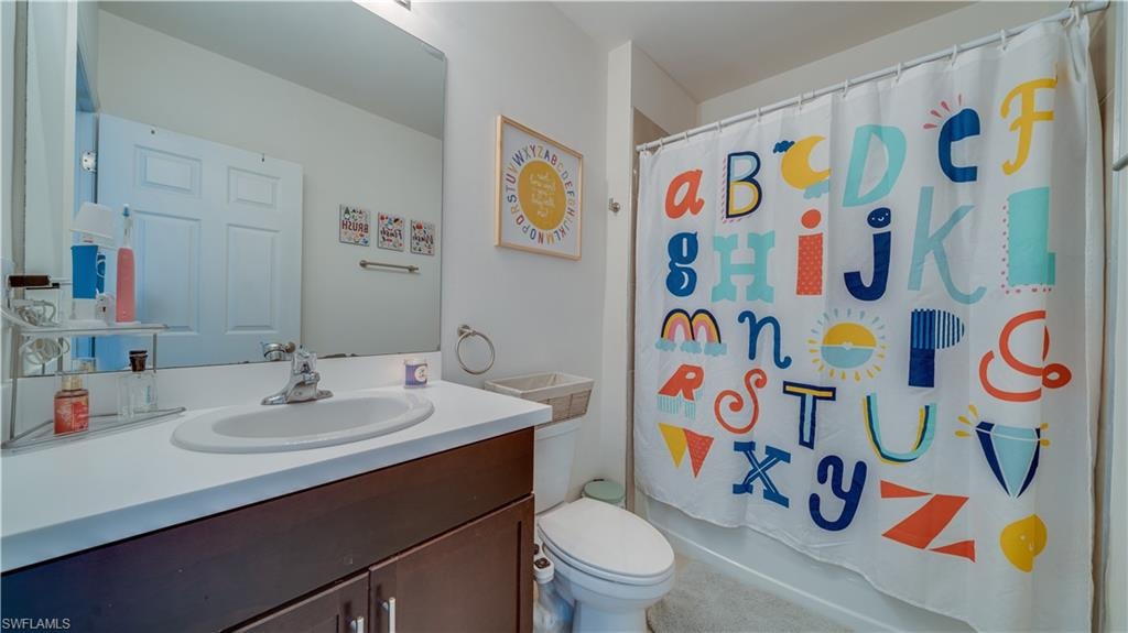 Bathroom with vanity and shower / tub combo with curtain