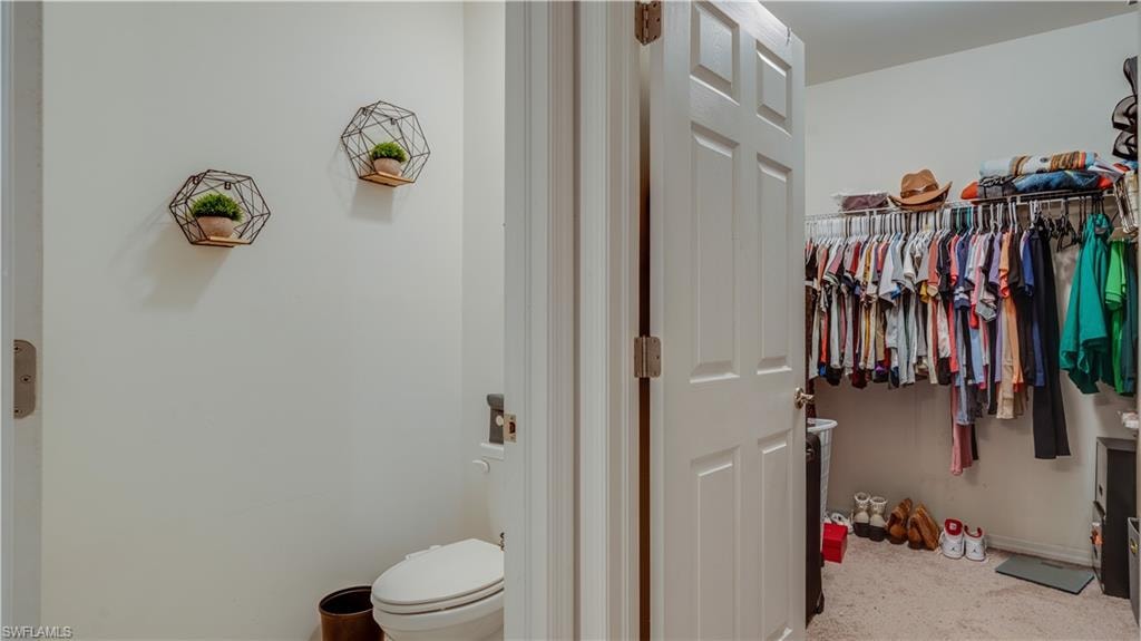 Bathroom with baseboards and a walk in closet