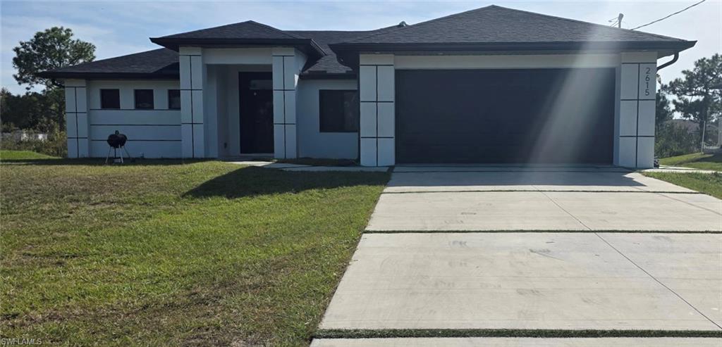 View of front of home featuring a shingled roof, concrete driveway, a garage, a front lawn, and stucco siding