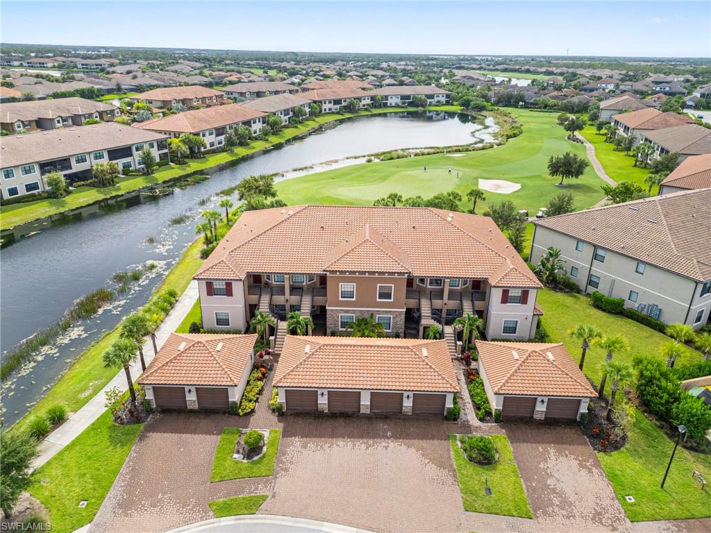 Aerial perspective of suburban area with a nearby body of water and a golf course