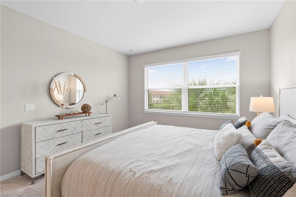 Bedroom featuring carpet floors and baseboards
