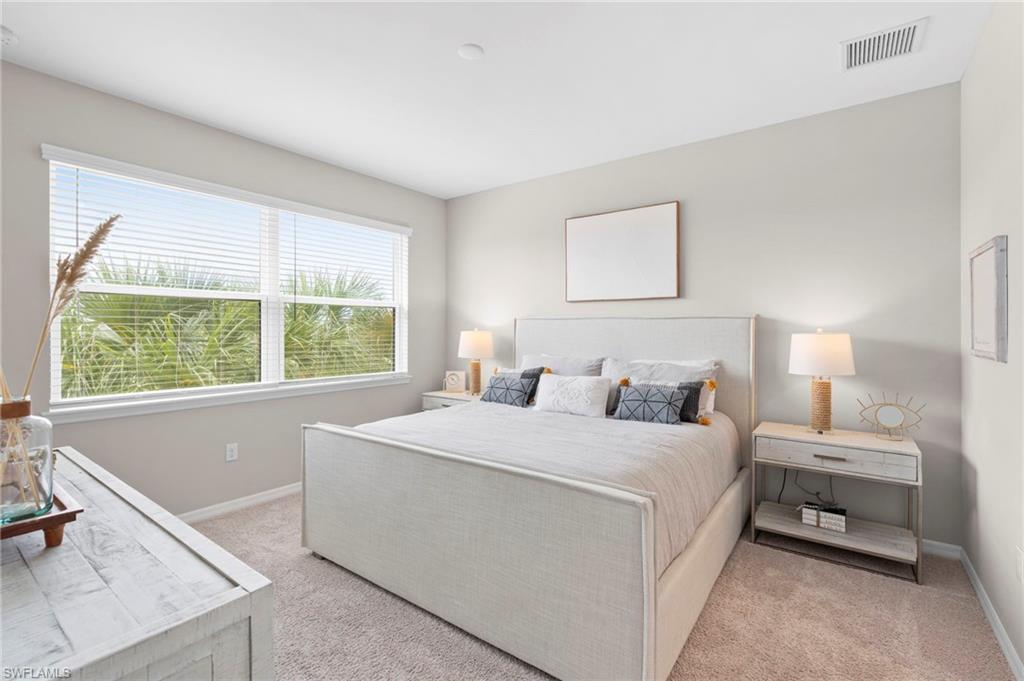 Bedroom with light colored carpet