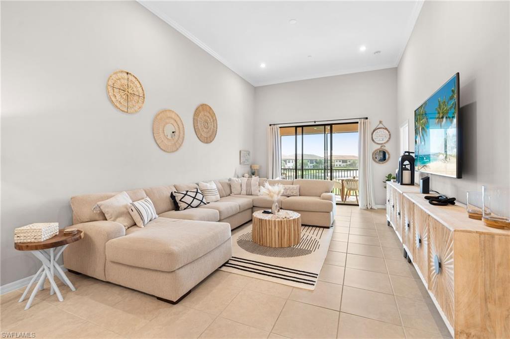 Living area featuring ornamental molding, light tile patterned floors, and recessed lighting