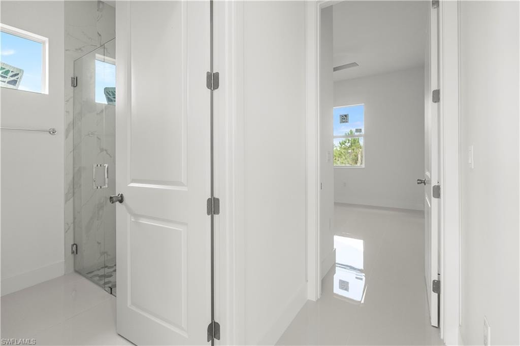 Corridor featuring healthy amount of natural light