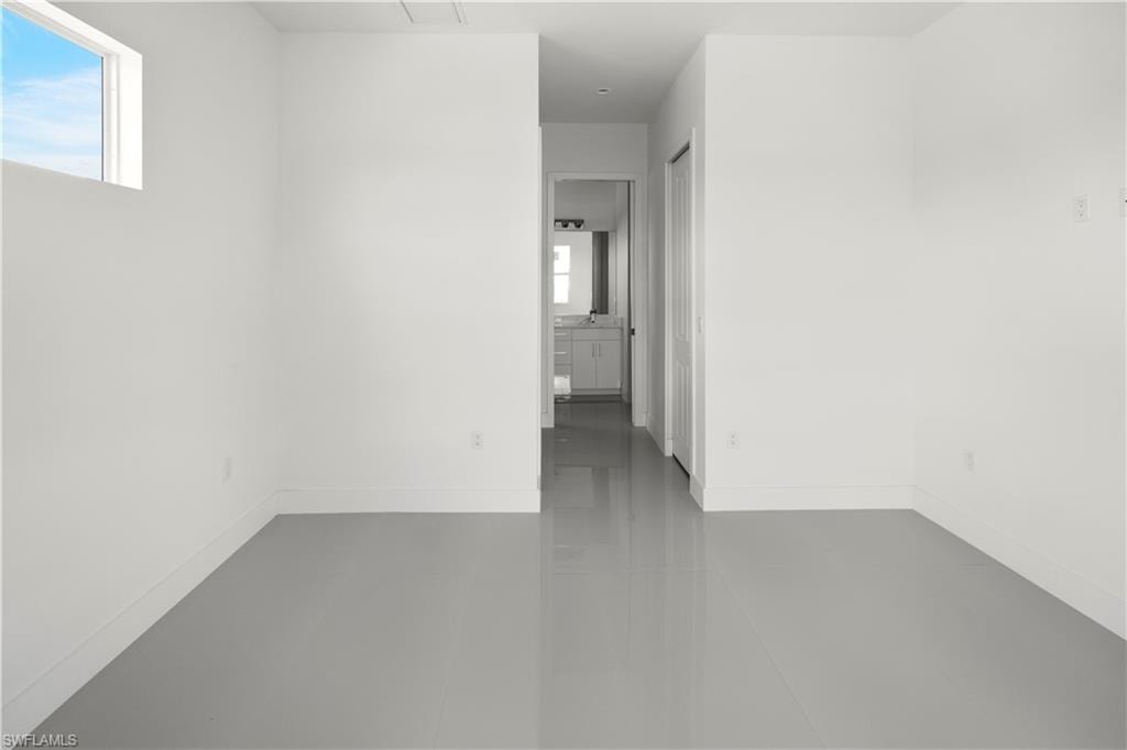 Spare room with baseboards and concrete floors