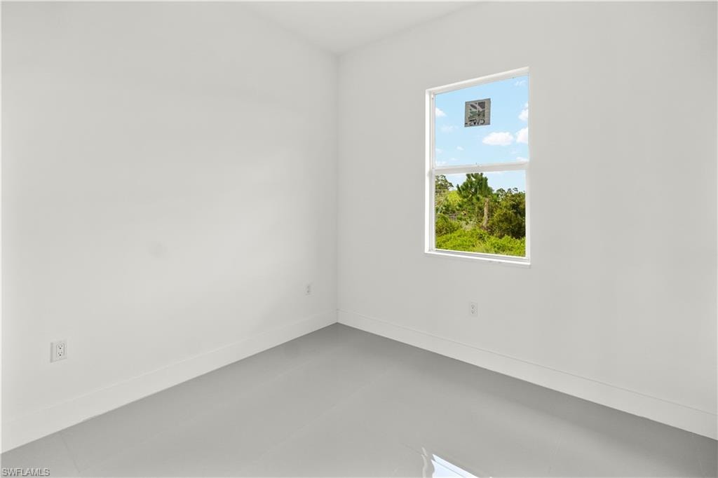 Unfurnished room with baseboards