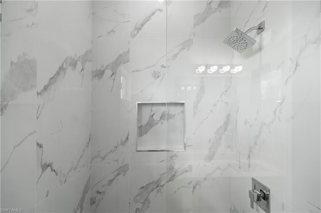 Full bathroom featuring a marble finish shower