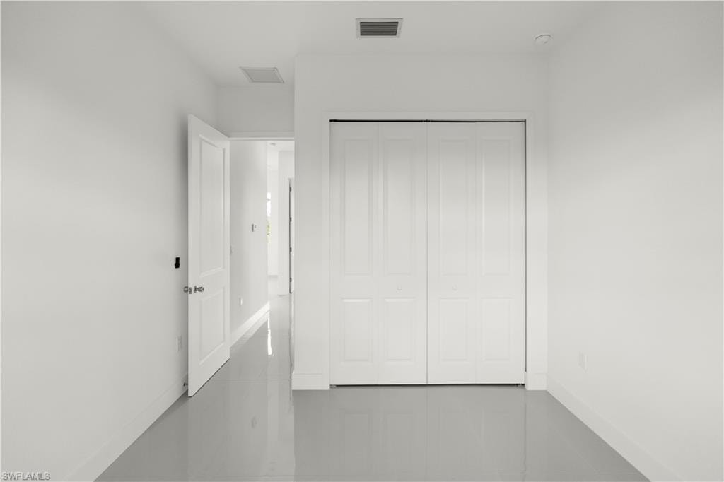 Unfurnished bedroom featuring baseboards and a closet