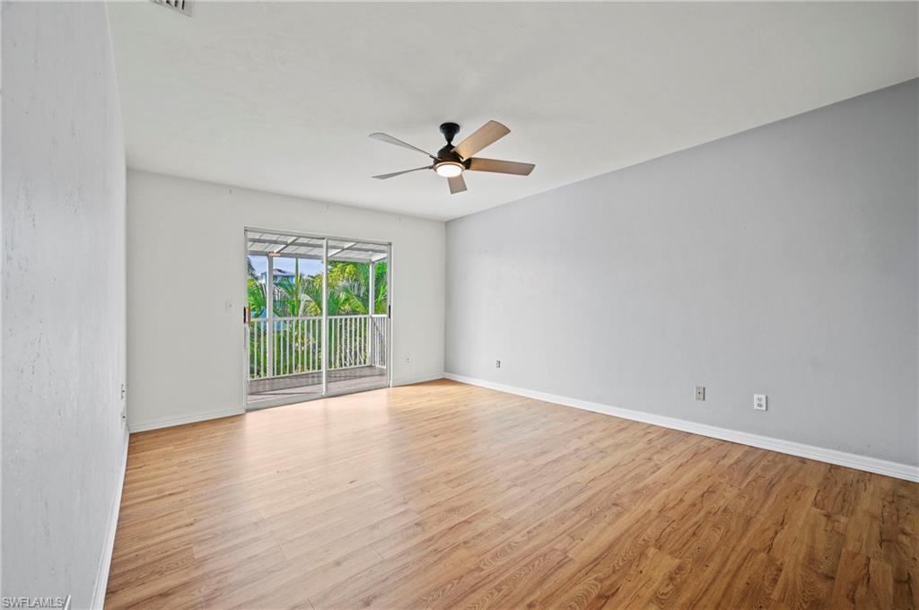 Spare room featuring light wood-style flooring and ceiling fan