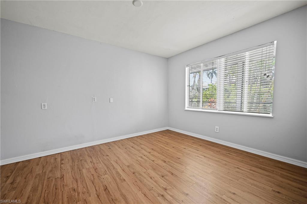 Empty room with wood finished floors and baseboards