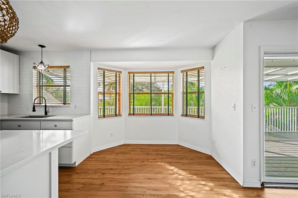 Unfurnished dining area with light wood-type flooring and plenty of natural light
