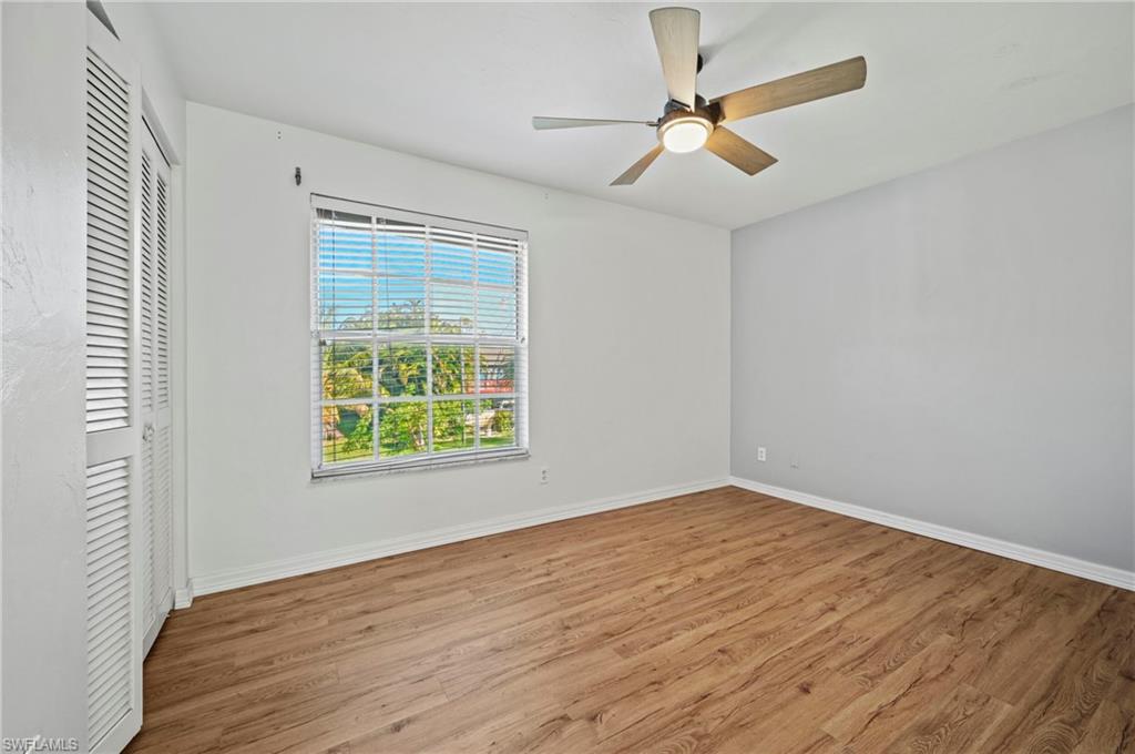 Unfurnished bedroom featuring wood finished floors, ceiling fan, and a closet