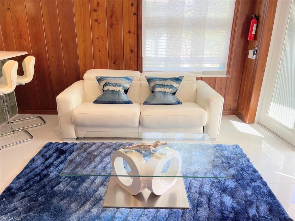 Living room featuring wooden walls