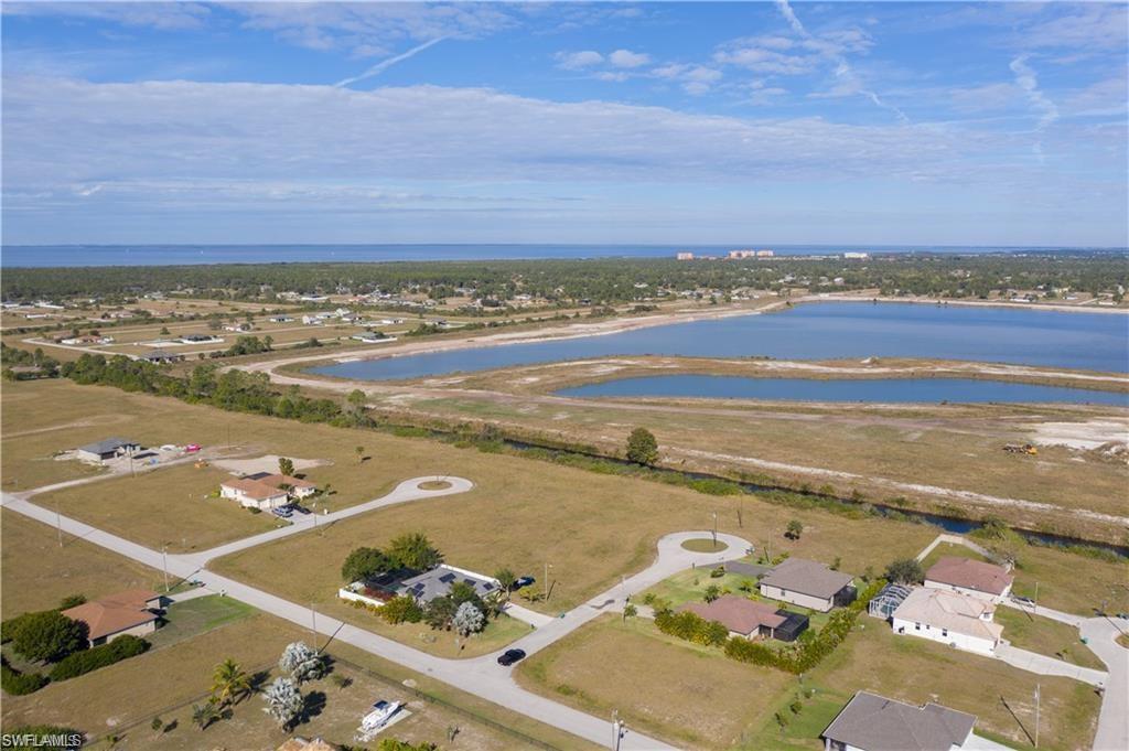 Aerial view of property's location with a large body of water