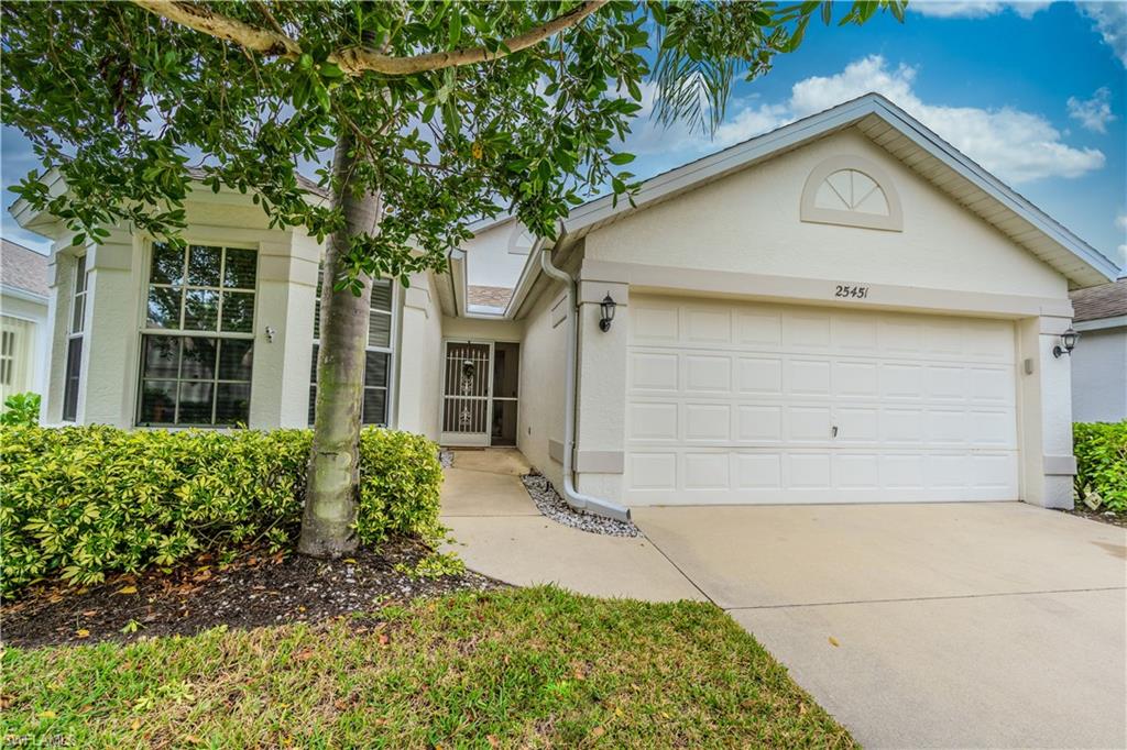 Ranch-style house with stucco siding, driveway, and a two car garage