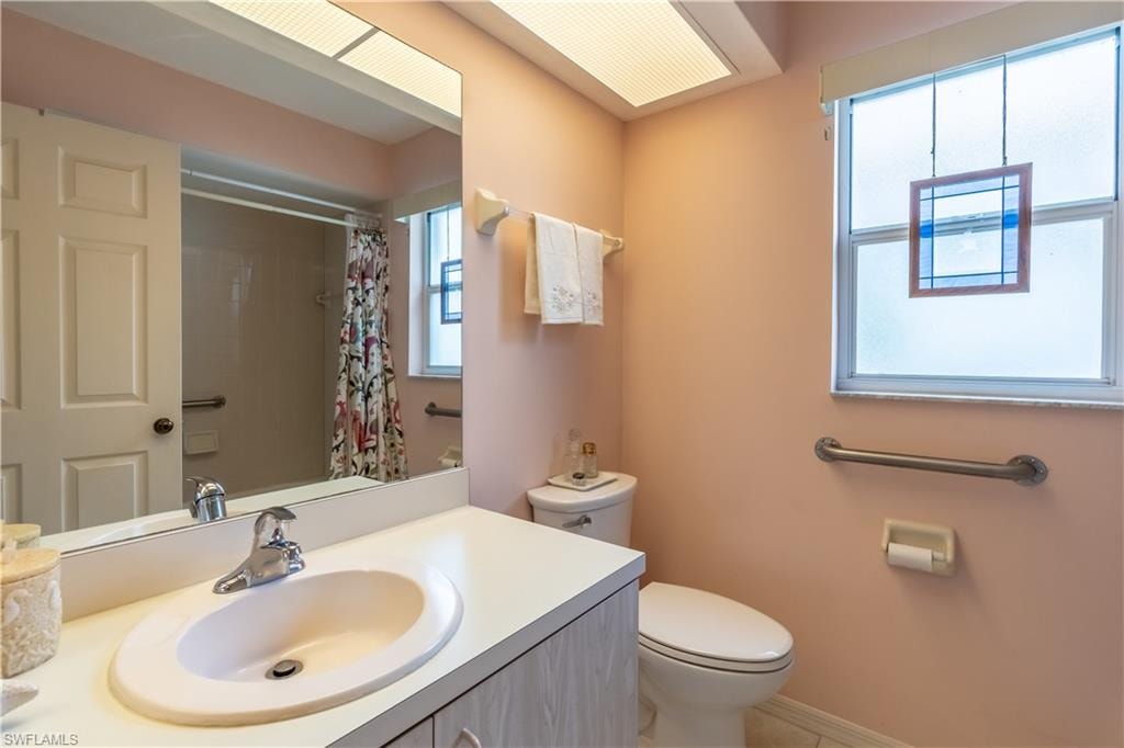 Full guest bathroom featuring vanity and a shower/tub combo