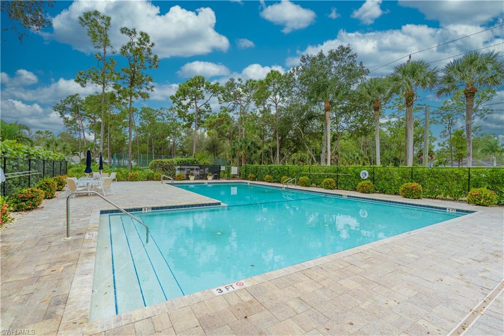 Community pool with a patio