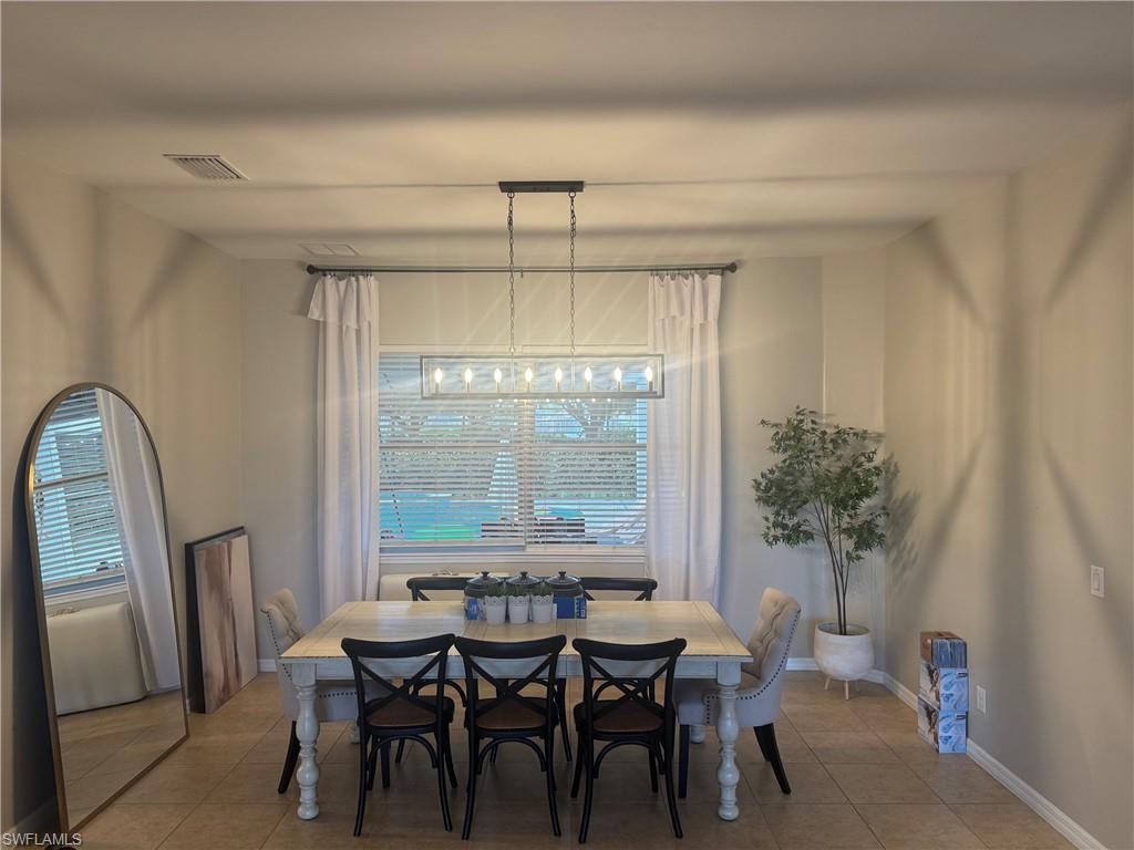 Dining space with tile patterned flooring