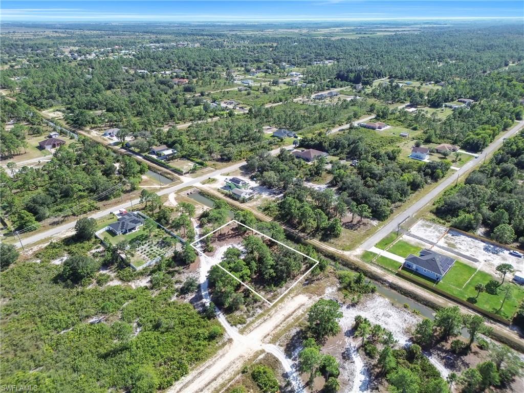 Aerial view of property and surrounding area with property parcel outlined